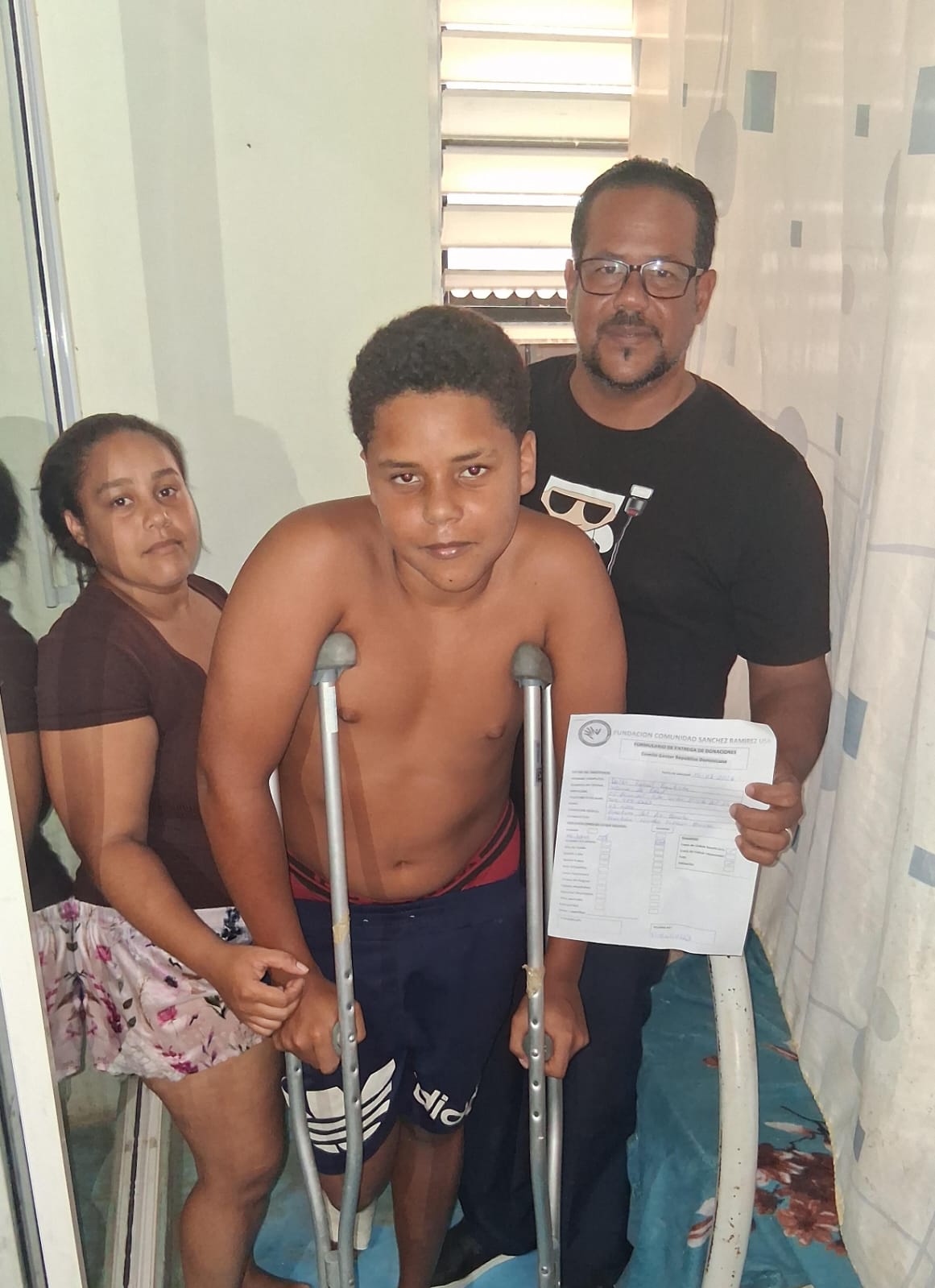 Young person with a disability receives crutches.