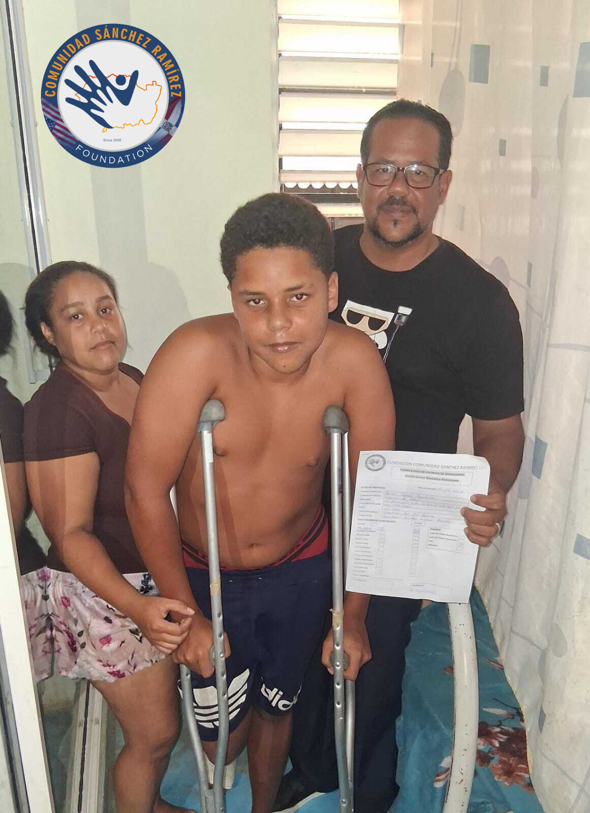 Young person with a disability receives crutches.